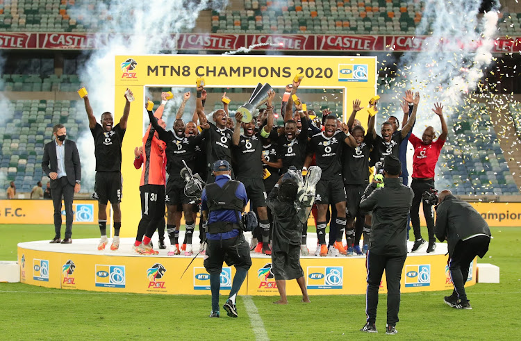 Orlando Pirates captain Thulani Hlatshwayo and his teammates celebrate after winning the 2020 MTN8 final as head caoch Josef Zinnbauer looks on.