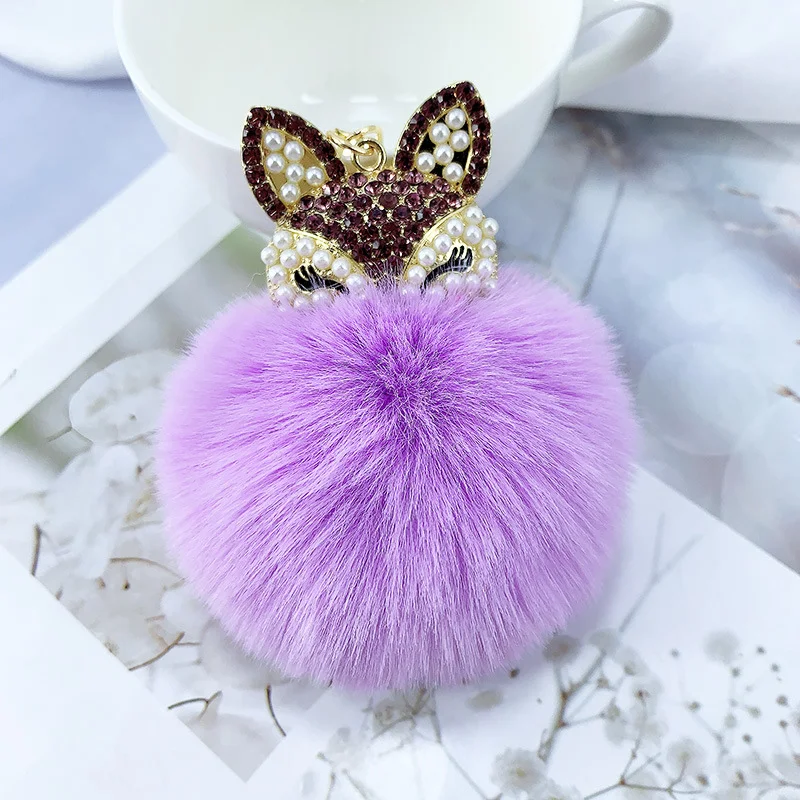 Sleutelhanger met legering parel strass vossenbont bal hanger, een stijlvolle en luxueuze accessoire voor uw sleutels of tas.