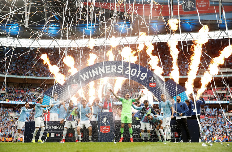 Manchester City players and staff celebrate after winning the FA Cup