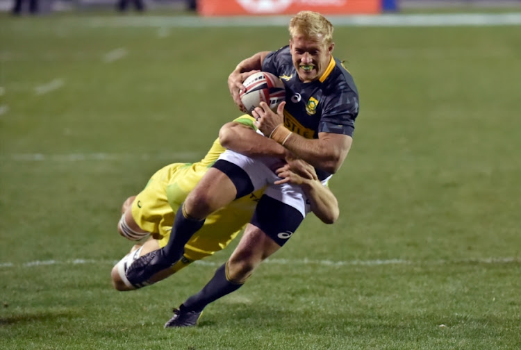 Kyle Brown of South Africa runs with the ball under pressure from Australia during day 2 of the 2018 HSBC USA Sevens at Sam Boyd Stadium on March 03, 2018 in Las Vegas, United States of America.