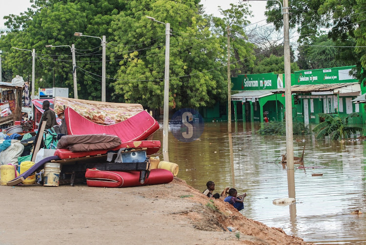 Families affected by floods in Mororo pack along the road after relocating when River Tana burst its banks following heavy rains on April 27, 2024.