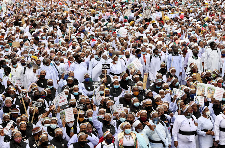 Women and men of the Nazareth Baptist church holding placards during their peace walk on Tuesday.