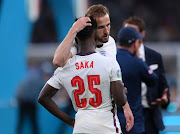 England captain Harry Kane consoles youngster Bukayo Saka after the 19-year-old missed in the penalty shootout. 