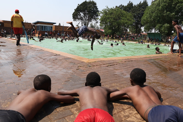 Children cool-off at the Moletsane public swimming pool as temperatues reach 34 degrees in Soweto.