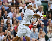 Roger Federer of Switzerland plays a forehand in his men's singles third round match against Cameron Norrie of Great Britain on day six of The Championships - Wimbledon 2021 at the All England Lawn Tennis and Croquet Club on July 03, 2021.