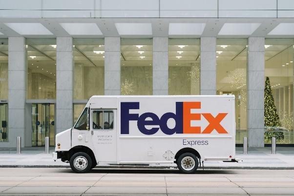 A white delivery truck parked in front of a building

Description automatically generated with medium confidence