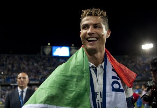 Real Madrid's Portuguese forward Cristiano Ronaldo smiles as he celebrates at the end of the Spanish league football match Malaga CF vs Real Madrid at La Rosaleda stadium in Malaga on May 21, 2017. Real Madrid won their 33rd La Liga title and first for five years as Cristiano Ronaldo's 40th goal of the season helped seal a 2-0 win at Malaga today.