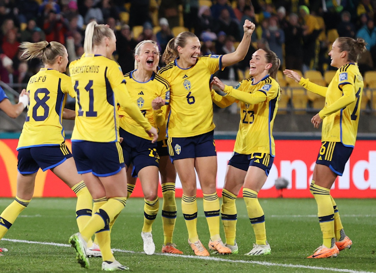 Sweden's Amanda Ilestedt celebrates scoring their fourth goal with teammates.