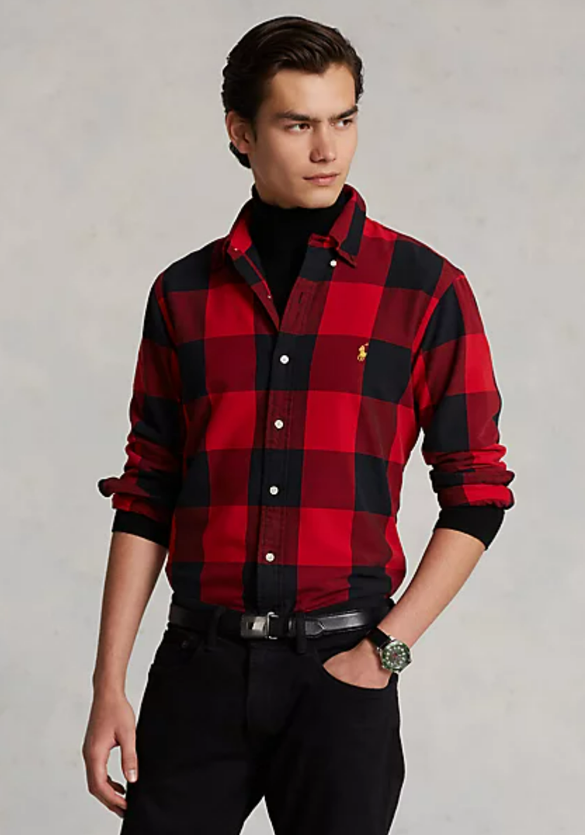 A person wearing a red and black plaid shirt and black pants</div><div class=