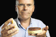 Professor Mark Post shows off the world's first lab-grown beef burger, which took five years and cost R3.3-million to make, in west London yesterday