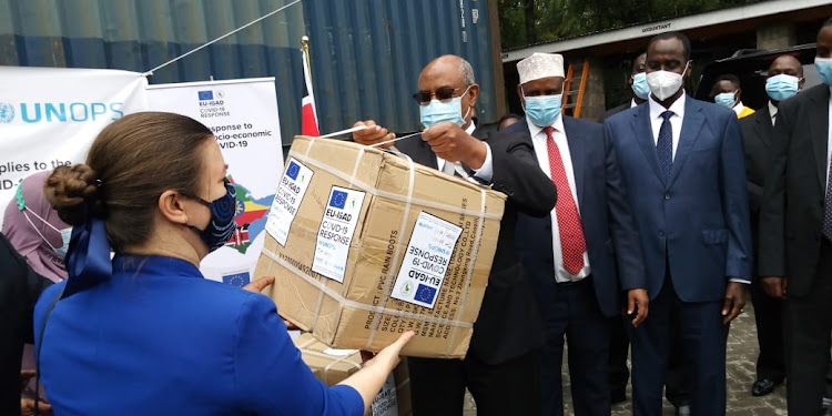 Health CAS Dr Rashid Aman lifts part of the donations during the handover at the Kenya Medical Training College Karen Campus on February 8, 2021