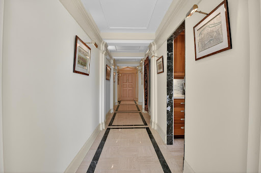 Hallway with doors and wall decorations in this luxury apartment / penthouse for sale in Washington ($375,000)