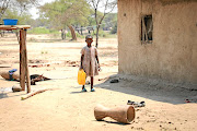 A little girl carries water at the Tongogara refugee camp in Zimbabwe. File photo.