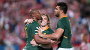 Makazole Mapimpi celebrates with Faf de Klerk and Damien de Allende after scoring his third try during the crushing Rugby World Cup warm up win over Japan. 