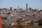 Alexandra township in Johannesburg needs SA's admired constitution and democracy to rectify the inequality between it and wealthy neighbour Sandton in the background. 