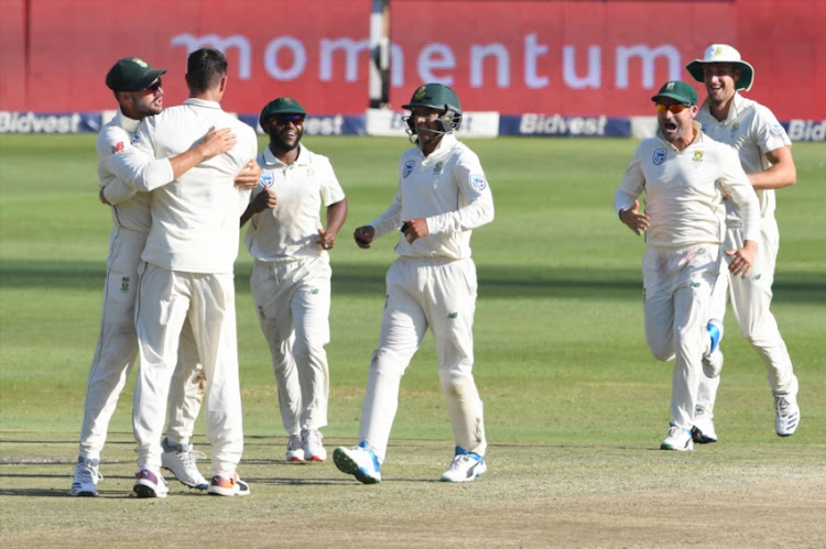 Duanne Olivier and Aiden Markram of the Proteas celebrate the wicket of Azhar Ali of Pakistan during day 3 of the 3rd Castle Lager Test match between South Africa and Pakistan at Bidvest Wanderers Stadium on January 13, 2018 in Johannesburg, South Africa.