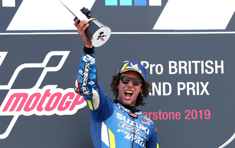 Suzuki's Alex Rins celebrates victory on the podium during the GoPro British Grand Prix MotoGP at Silverstone, Towcester.