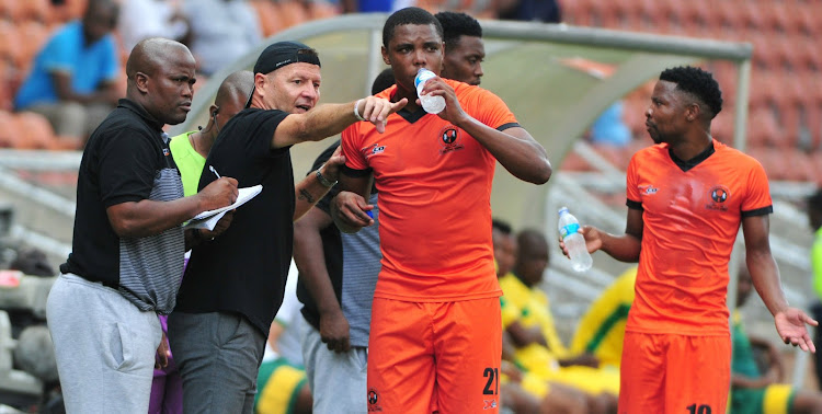 Polokwane City head coach Jozef Vukusic (wearing a cap) and his assistant Bernard Molekwa (L) dish out instructions to his players during an Absa Premiership match at Peter Mokaba Stadium in Polokwane.