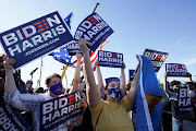 Supporters of Democratic US presidential nominee Joe Biden celebrate near the site of his planned election victory celebration after news media declared Biden to be the winner of the 2020 US presidential election in Wilmington, Delaware, US, November 7, 2020. 