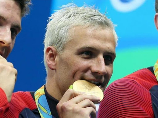 Aug 9, 2016; Rio de Janeiro, Brazil; Conor Dwyer (USA) , Townley Haas (USA) , Ryan Lochte (USA) and Michael Phelps (USA) with their gold medals after the men's 4x200m freestyle relay final in the Rio 2016 Summer Olympic Games at Olympic Aquatics Stadium./REUTERS