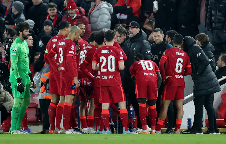 Liverpool manager Jurgen Klopp talks to the players as play is stopped due to a medical emergency in the stand during a Champions League Round of 16 second leg against Inter Milan at Anfield on March 8