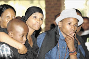 DIFFICULT TIME:   Tina Jaxa and her two sons during the memorial service of her late husband Prosper Mkwaiwa held at Die Draai in Bronkhospruit, Mpumalanga  Photo: Mabuti Kali