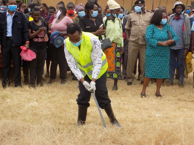 Shipping and Maritime Affairs’ Principal Secretary Nancy Karigithu cutting grass with a slasher at Embu stadium when she launched Kazi Mtaani Pogram for youth from informal sector in the county