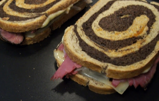 Marble Rye Bread with provolone, corned beef and kraut with a thousand island dressing.