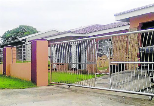 ALL STOLEN: Thembisa Twani and her daughter, Phili Sifile, right, stand next to the empty space in Northcrest where her R89 000 chrome gate, left, used to be Picture: ZIPO-ZENKOSI NCOKAZI