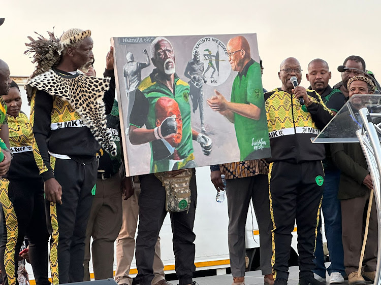 MKP leader Jacob Zuma presents a painting to Malesela 'King Sebetha' Mkonyama after he completed his walk to Nkandla.