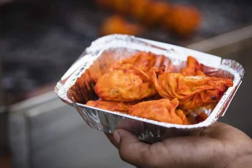 Pan Fried Veggie Momos In Tomato Sauce [6 Pieces]