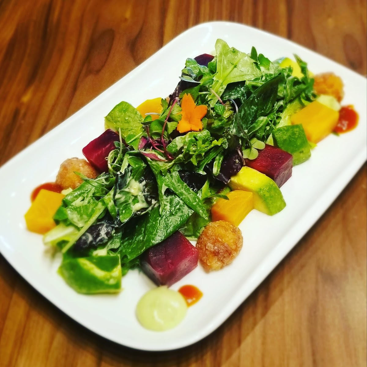 Smoked Beet Salad: lemon avocado aioli, topped fried rice.