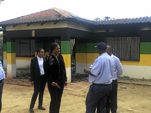 Community safety MEC Gabi Shabalala inspecting the damage at the ANC constituency office that was burnt down by the protesters in Barbeton. / MANDLA KHOZA