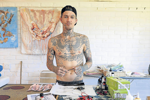 KWELERA INK: Cape Town tattoo artist and model Daniel Lotz set up a pop-up tattoo parlour in his mother’s seaside Kwelera art studio for East London clients who are keen to get inked Picture: STEPHANIE LLOYD