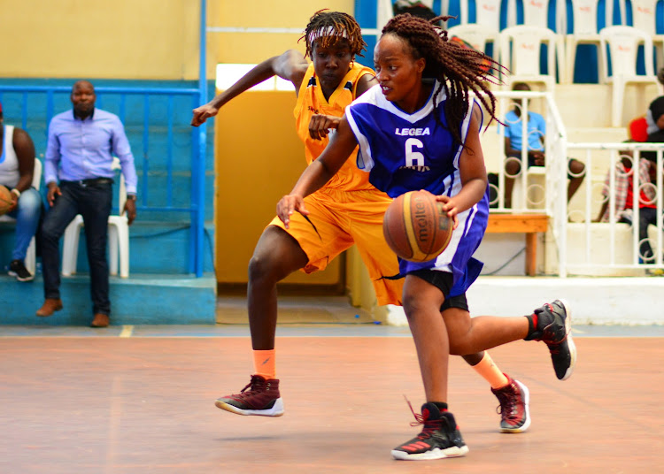 Teresa Ekise from KU Oryx (R) challenges Lisa Mayienga of USIU during a past KBF Premier League match at Nyayo