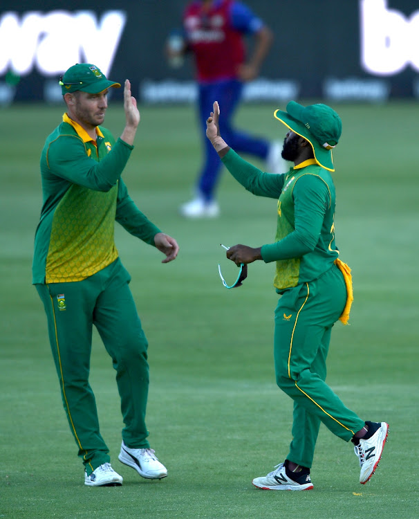 David Miller and ODI captain Temba Bavuma celebrate the fall of a wicket in previous action.