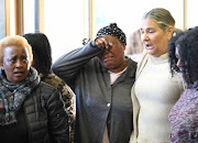  Women mourn the death of UCT student Uyinene Mrwetyana at the Clareinch post office, where she was apparently lured by her attacker.