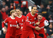 Alexis Mac Allister celebrates scoring Liverpool's goal with Virgil van Dijk in their Premier League draw against Manchester City at Anfield in Liverpool on Sunday.