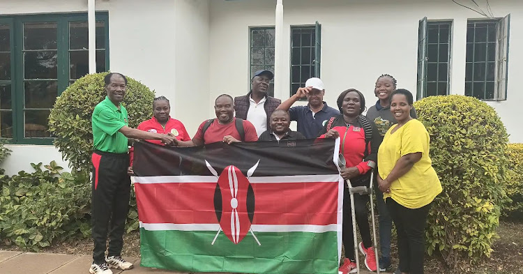Tennis Kenya President James Kenani hands over the flag to Rajab Athman and the Kenya wheelchair team before departure