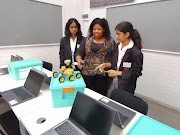 Mountview pupils and teacher Xoli  Mahlangu play in the newly launched robotics lab at their school in Verulam, north of Durban.