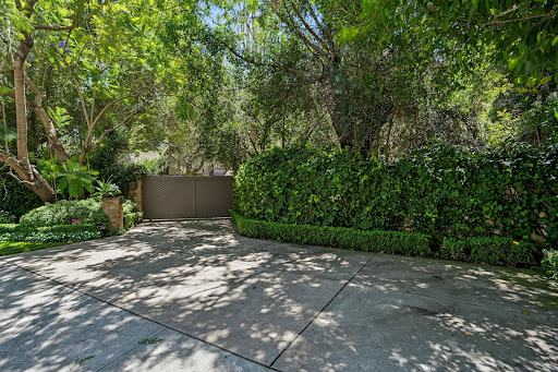 Driveway leading to a mesh gate in this luxury property for rent in Los Angeles ($35,000)