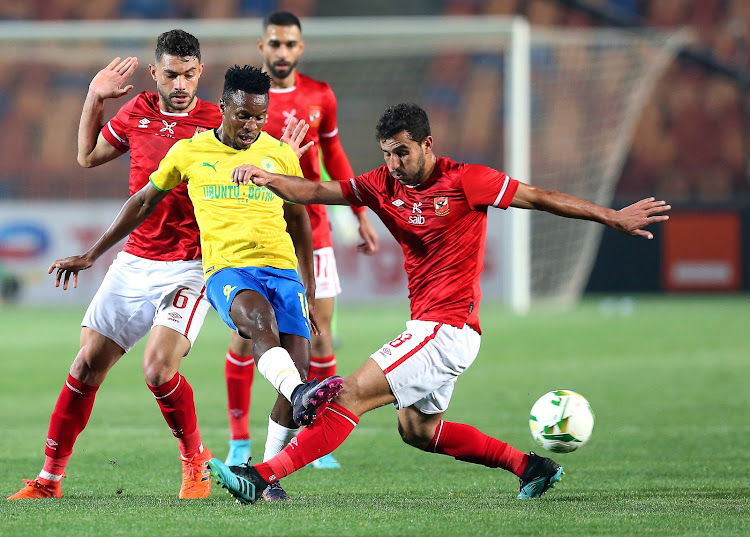 Mamelodi Sundowns midfielder Themba Zwane in a tussle for the ball with Al Ahly's Hamdi Fathi (R) during their CAF Champions League group stages match in Cairo.