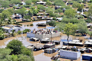 A handout aerial photo taken on January 25, 2013 and provided on January 29 by the non-governmental organization Mercy Air Switzerland shows people camping on roofs in the devastated southern Mozambican town of Chokwe, which has borne the brunt of the flooding caused by heavy rains. Officials said on January 29 that the military had been called in to help tackle severe flooding that has killed 48 people and is likely to spread to the country's central and northern regions. At temporary shelters aid agencies are feeding approximately 70 000 people.