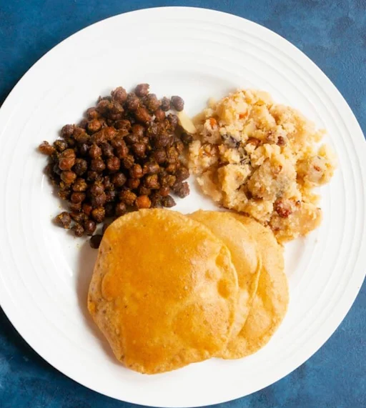 Aloo Poori (4pcs)+Suji Halwa+Kala Chana Masala From Mum's Kitchen."