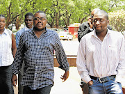 HARASSED: Nevanji Madanhire (left), editor of the Standard, and reporter Nqaba Matshazi arrive at the Harare Magistrate's Court this week. They were charged with criminal defamation after the publication of a story about businessman Munyaradzi Kereke's medical aid company, GreenCard