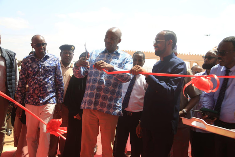 Education CS Ezekiel Machogu cuts the ribbon when he officially opened the Mandera Teacher Training College.Looking on are local leaders led by governor Mohamed Adan[R]