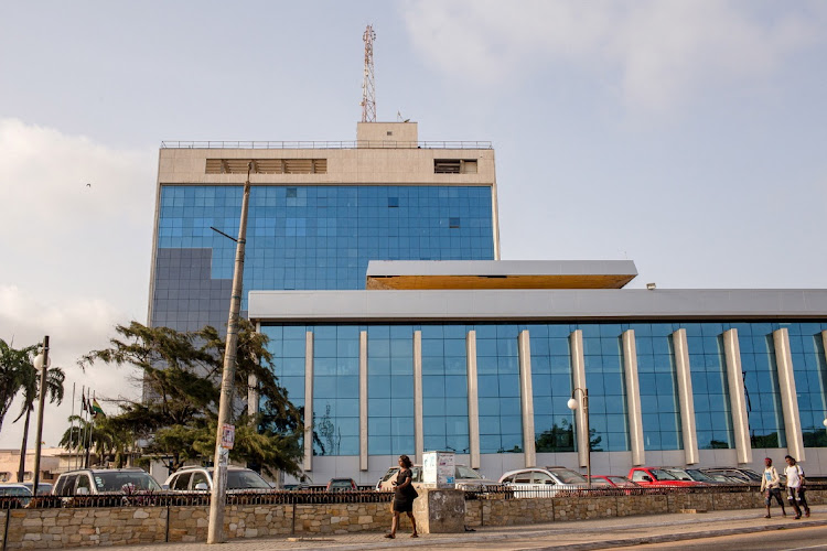 Pedestrians walk in front of GCB Bank, the country's leading commercial bank, in Accra, Ghana. File photo.