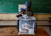 An elderly woman casts her ballot at a polling station on the day of the presidential election, in Kinshasa, the Democratic Republic of Congo on December 20, 2023.