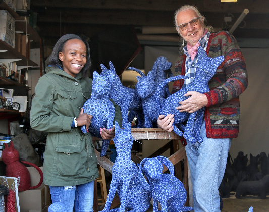 Naomy Maxhakane and Rolf Werner with some of the 50 shweshwe dogs and cats that were made in a Dorchester Heights garage in East London and will be the table centrepieces of an upmarket gala dinner in New York.