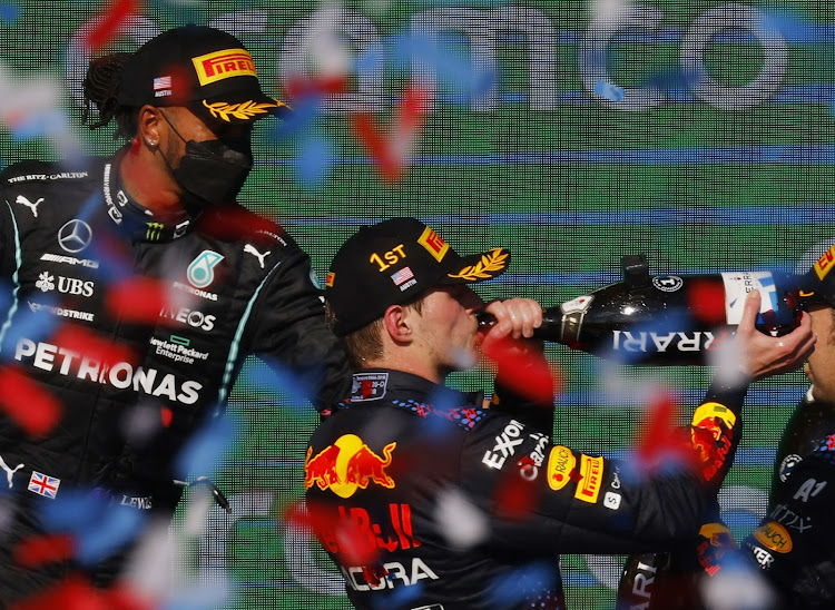 Red Bull's Max Verstappen and Mercedes' Lewis Hamilton celebrate on the podium during the United States Grand Prix